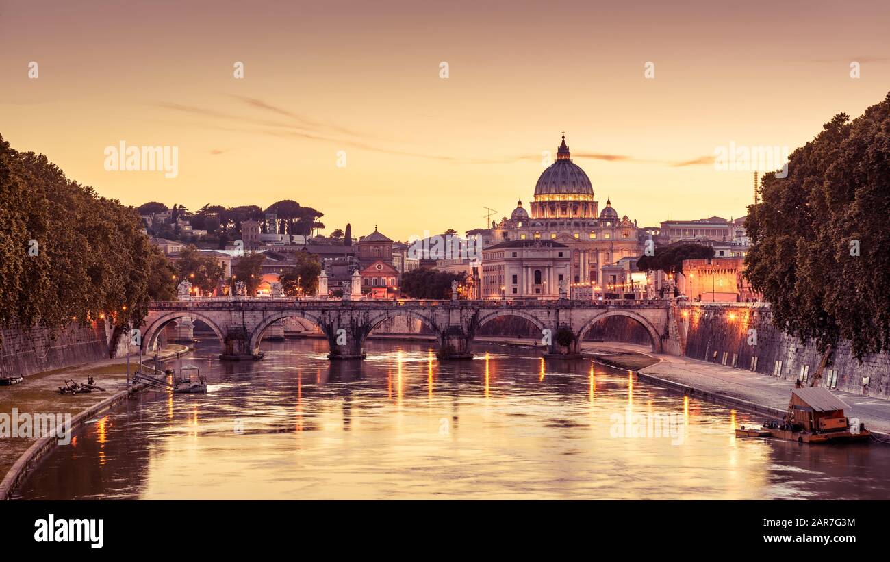 Rome at night, Italy. Sant`Angelo bridge and St Peter's Basilica. Rome landmark. Saint Peter's Basilica (San Pietro) is one of main travel attractions Stock Photo